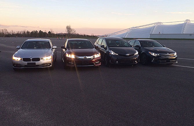 In this photo provided by the The Insurance Institute for Highway Safety, from left, a BMW 3 series, Honda Accord, Toyota Prius V and a Kia Optima are seen at the institute's Vehicle Research Center in Ruckersville, Va. A new study that rates the headlights of more than 30 midsized car models found only one model earned a "good" rating. Of the rest, half were rated "acceptable" and half were rated "poor." The difference between the top-rated and bottom-rated model in terms of a driver's ability to see down a dark road was substantial. 