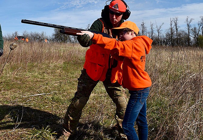 Kylyn Luckfield, a WOLF school participant, receives proper shooting instruction from Shawn Gamer, Missouri Department of Conservation resources assistant. (2016 photo)