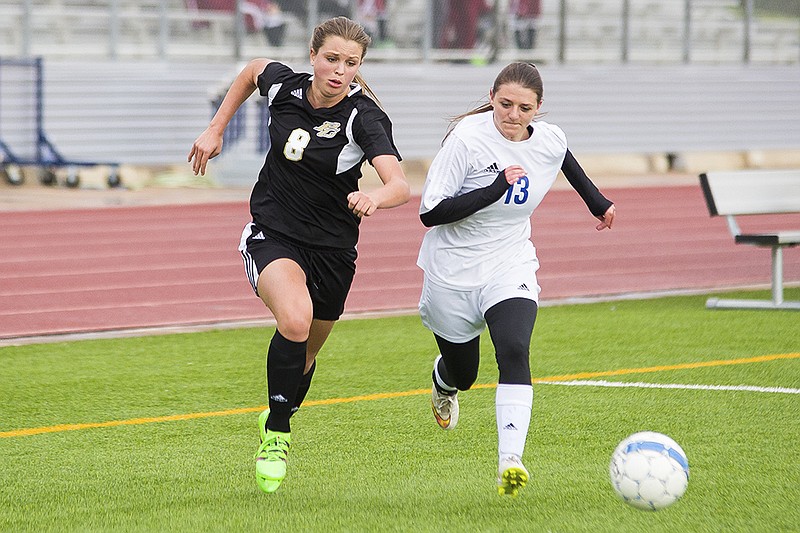 Pleasant Grove's Brooklyn Puzz and Spring Hill's Tara Pleasant battle for control of the ball Friday, Apr. 1, 2016 in Longview, Texas.