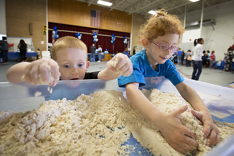 Levi Phillips, 4, and his sister Nevaeh, 6, play in moon sand Saturday, Apr. 2, 2016 at the third annual Moms on a Mission for Autism Awareness rally held at Liberty-Eylau Pre-K. Sixteen agencies were on hand to entertain children and educate parents on resources. More than 100 area children and their parents were expected to attend. Doterra Wellness' moon-sand station is aroma/sensory therapy. To find out more about the group, check their Facebook page for upcoming events. 