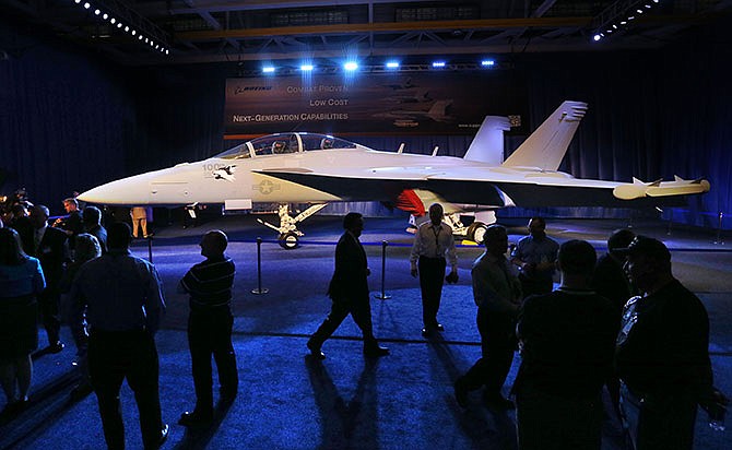 This photo taken May 5, 2014, shows workers walking around an EA-18G Growler produced at the Boeing plant in St. Louis after a rally celebrating delivery of the 100th Growler to the Navy. Federal spending in Missouri in 2014 was the equivalent of 22.8 percent of the state's economy, tying it with Rhode Island for 18th nationally among the states. (David Carson/St. Louis Post-Dispatch via AP)