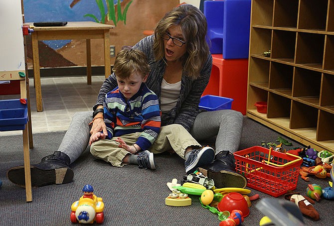 Greta Hull, director of the Robert G. Combs Language Preschool, plays with William Beversdorf, 4, at the preschool on March 24, 2016, in Columbia, Mo. Beversdorf was born prematurely and struggles with speaking and interacting with other children. (Mike Krebs/Columbia Missourian via AP)