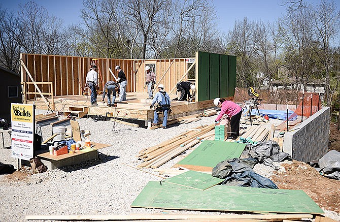 Volunteers work on erecting a wall of Habitat for Humanity and Thrivent Financial's 11th sponsored home in Jefferson City on Saturday at 316 Gateway Drive. Once finished, the house will be home to Maria Velazquez and her 7-year-old daughter.