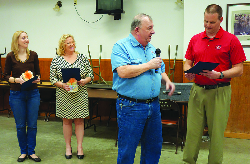 Tom Ward, holding microphone, presents awards to the three local teachers selected to represent the Basinger/Sone Memorial VFW Post 1003 in the 2016 Smart/Maher VFW National Citizenship Education Teacher Award Contest. Ward is the past commander of the post. The teachers, from left, are Natalie Altheuser, Libby Hafley and Chad Rizner.