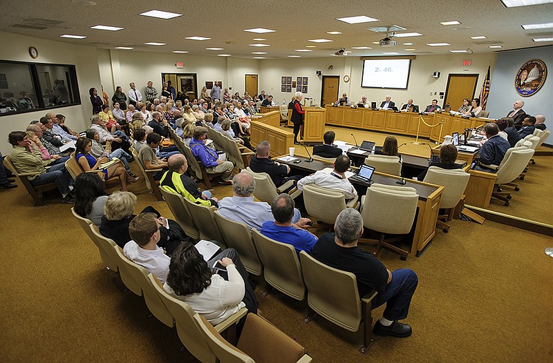 A large audience fills the City Council chambers as Hayselton Drive resident Shirley Denkler voices her opposition to the proposed River Bluff Estates subdivision and its Hayselton Drive access.