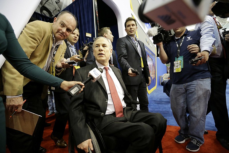 Texas Gov. Greg Abbott arrives in the Spin Room on Feb. 25 before the Republican presidential primary debate at The University of Houston. Abbott has written a book detailing how he overcame an accident that left him paralyzed from the waist down and outlines his plan to "restore the Constitution." 