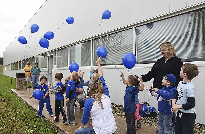 Young students release blue balloons in recognition of Autism Awareness month during an event Wednesday at the Missouri Department of Health and Senior Services.