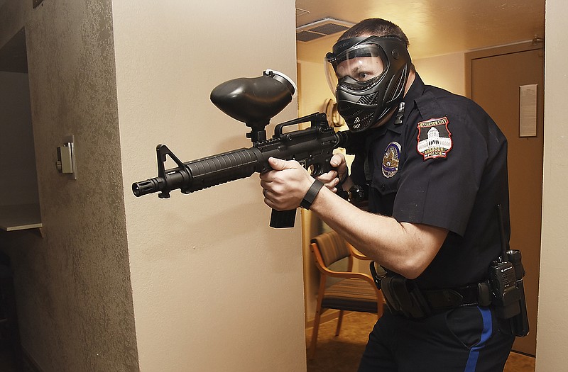 JCPD officer Zach Kolb performs a sweep of the room during training Thursday afternoon at the vacant Truman Hotel. The Jefferson City Police Department has been offered use of the now-closed hotel for tactical training. One of Thursday's scenarios was the case of an active shooter during which they trained in teams of two and four to take down the shooter and to search rooms for accomplices.