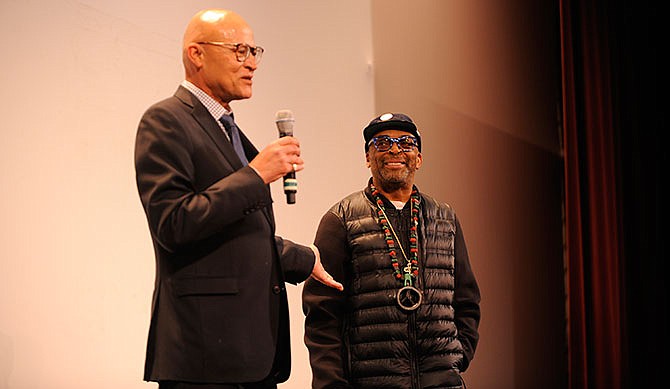 Interim UM Systems President Mike Middleton, left, introduces filmmaker Spike Lee before the premiere of "2 Fists Up", Spike Lee's documentary about protests at the University of Missouri, at the Missouri Theatre on Wednesday, April 6, 2016, in Columbia, Mo. Lee worked with ESPN to make the documentary, which examines how the Black Lives Matter movement sparked activism at the University of Missouri. (Mikala Compton/Missourian via AP) 