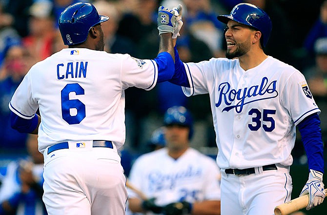 Kansas City Royals' Lorenzo Cain (6) is congratulated by teammate Eric Hosmer (35) after his solo home run in the fourth inning a baseball game against the Minnesota Twins at Kauffman Stadium in Kansas City, Mo., Saturday, April 9, 2016.