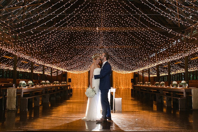 This Sept. 2015 photo provided by Mandee Morgan shows Mandee and Thor Morgan during their wedding reception at Camp Highlander in Horse Shoe, N.C. Summer-camp weddings are a hot new twist on the destination wedding. 