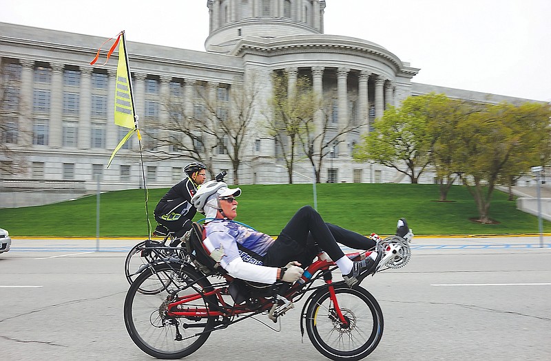 Springfield cyclists Ray Van Ostran, foreground, and David Rice were among those cycling around the Capitol over the weekend in advance of today's Missouri Bicycle and Pedestrian Federation advocacy day at the Capitol. Among other things, they are opposing a bill that would require cyclists to have 15-foot poles mounted on their bikes with flags on top. They also oppose a bill that would allow disabled residents to use ATVs on the Katy Trail.