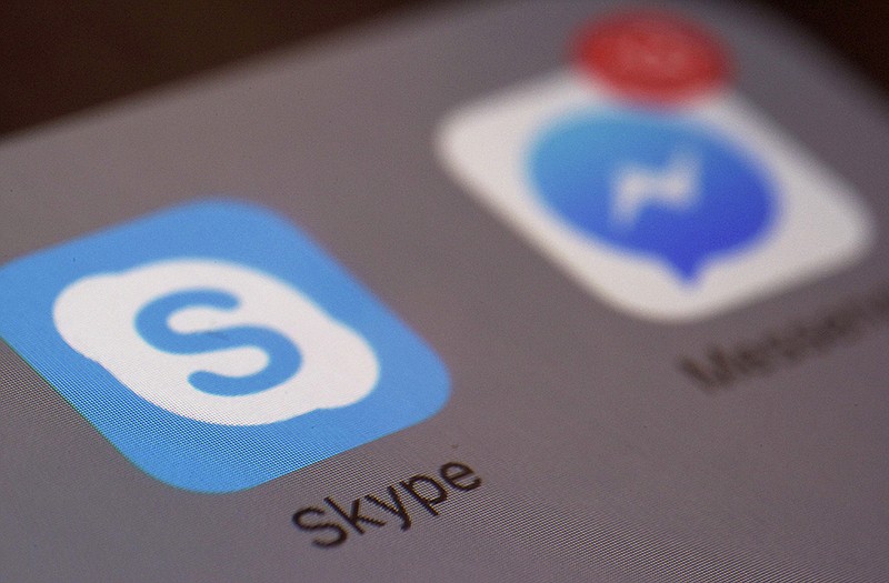 The logo for Skype, an online messaging and video chat application, is shown above on a digital device. 