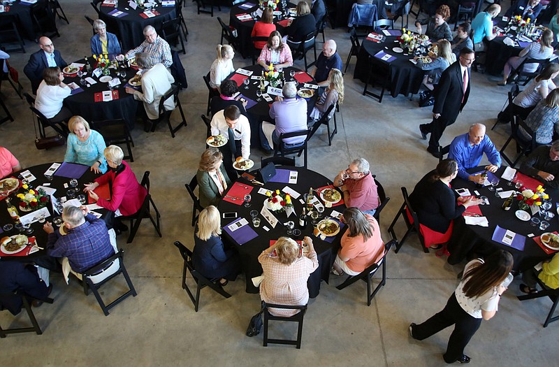 Diners wait to be served at the Dinner for a Difference. Their place mats determined if they were wealthy, middle-class or in poverty.