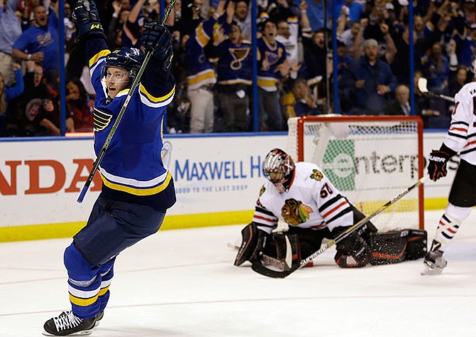 St. Louis Blues' Vladimir Tarasenko, left, of Russia, celebrates after scoring past Chicago Blackhawks goalie Corey Crawford, second from left, during the second period in Game 2 of an NHL hockey first-round Stanley Cup playoff series Friday, April 15, 2016, in St. Louis. 