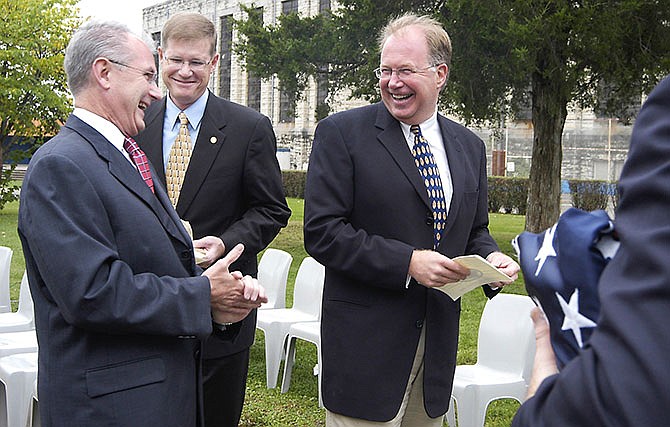 Then Missouri Gov. Bob Holden, left, Rep. Mark Bruns and Sen. Carl Vogel, right, share a light-hearted moment in 2004 after ceremonies to decommission the Missouri State Penitentiary in Jefferson City.
