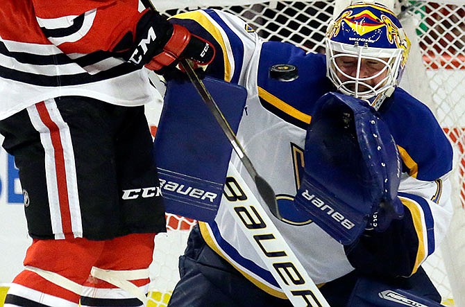 St. Louis Blues goalie Brian Elliott blocks a shot by Chicago Blackhawks right wing Andrew Shaw during the second period in Game 4 of an NHL hockey first-round Stanley Cup playoff series Tuesday, April 19, 2016, in Chicago.