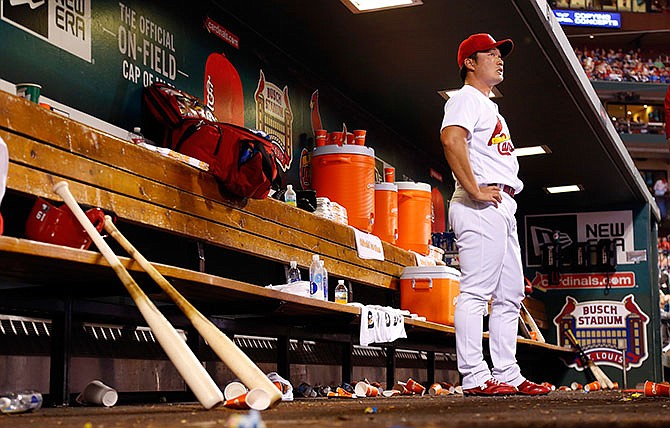 St. Louis Cardinals relief pitcher Seung Hwan Oh, of South Korea, stands in the dugout after working during the sixth inning of a baseball game against the Chicago Cubs Tuesday, April 19, 2016, in St. Louis.