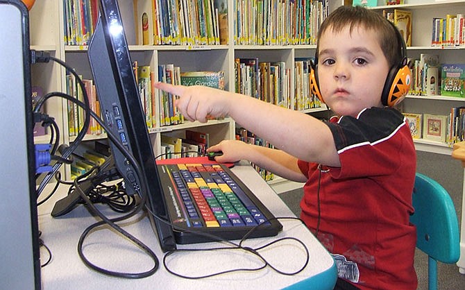 Charlie Barker, 4, loves playing computer games at the Moniteau County Library, such as Dora the Explorer on Nick Jr. Games as seen here. But his mom, Bethany Pace, loves it just as much since the library rearranged the placement of the computers in the children's section so mom can be near her son while her son has better access to the computers.