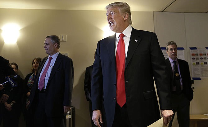 Republican presidential candidate Donald Trump talks to reporters while voting in New York, Tuesday, April 19, 2016. 