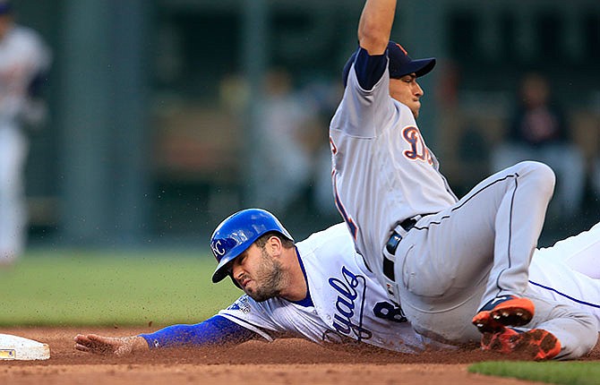 Kansas City Royals' Mike Moustakas (8) is tagged out by Detroit Tigers shortstop Jose Iglesias during the third inning of a baseball game at Kauffman Stadium in Kansas City, Mo., Wednesday, April 20, 2016. Moustakas was caught stealing on the play. 