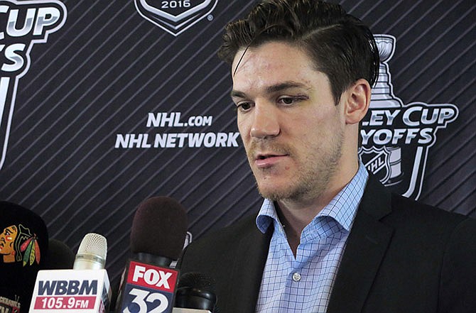 Chicago Blackhawks forward Andrew Shaw talks to reporters before the team left for St. Louis on Wednesday, April 20, 2016, at Chicago's O'Hare International Airport. Blackhawks forward Andrew Shaw apologized Wednesday for yelling an anti-gay slur at someone on the ice after he was sent to the penalty box late in Chicago's Game 4 loss at home to the St. Louis Blues.