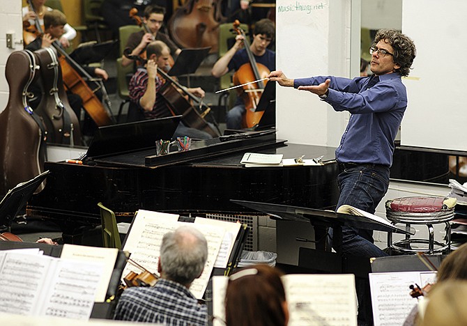 Music director and conductor Patrick David Clark leads members of the Jefferson City Symphony Orchestra during a rehearsal session at Jefferson City High School. 