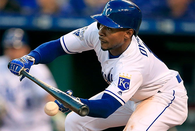 Kansas City Royals Jarrod Dyson hits a sacrifice bunt during the fourth inning of a baseball game against the Detroit Tigers at Kauffman Stadium in Kansas City, Mo., Thursday, April 21, 2016. Dyson moved Omar Infante to third base on the play. 