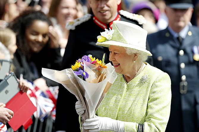 Britainâ€™s Queen Elizabeth II meets well wishers during a walkabout to celebrate her 90th birthday Thursday in Windsor, England. The queen was born Princess Elizabeth on April 21, 1926, and became queen at 25 upon the death of her father, King George VI, in 1952. 