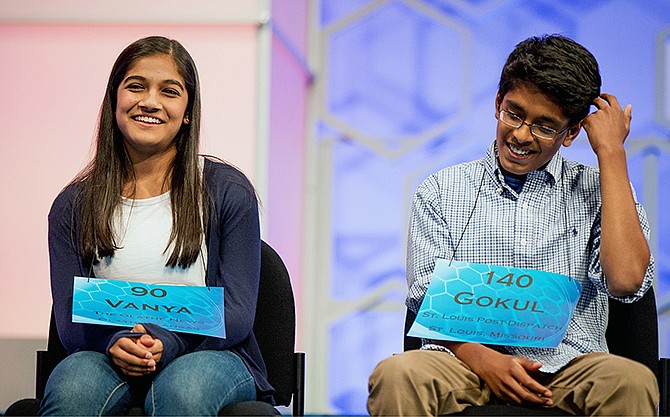 The remaining two spellers Vanya Shivashankar, left, of Olathe, Kansas, and Gokul Venkatachalam, of St. Louis, sit onstage during the 2015 finals of the Scripps National Spelling Bee in Oxon Hill, Maryland.