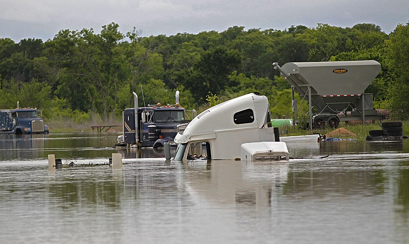 Trucks at a repair shop in Texas Highway 114 are flooded as Lake Bridgeport continues to rise with runoff from recent rains, in Bridgeport, Texas, Wednesday, April 20, 2016. The death toll has reached several in Southeast Texas flooding after storms dumped more than a foot of rain.