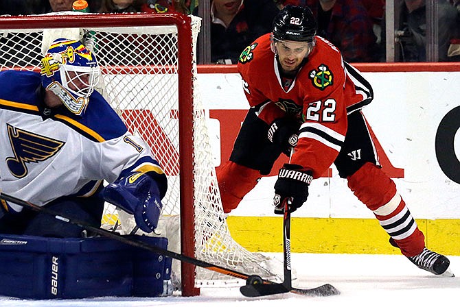 Chicago Blackhawks center Marcus Kruger, right, shoots against St. Louis Blues goalie Brian Elliott during the second period in Game 6 of an NHL hockey first-round Stanley Cup playoff series Saturday, April 23, 2016, in Chicago. 