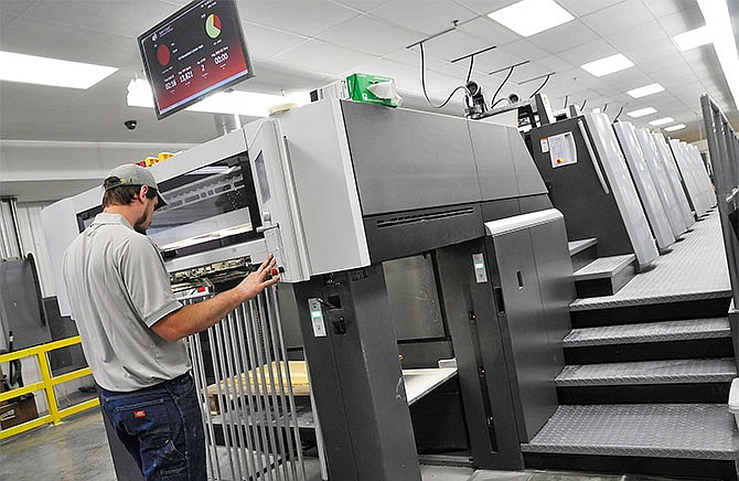 This July 2015 file photo shows Pressman Kurtis Uthe operating the Heidelberg Speedmaster press at Modern Litho in Jefferson City. A City Council approved tax incentive will allow the company to add a fourth press and 50 new jobs.