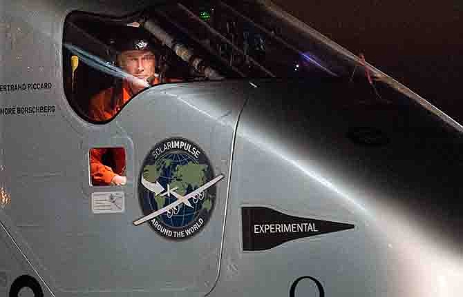 Solar Impulse 2 pilot Bertrand Piccard looks out his cockpit window Saturday shortly after landing at Moffett Field in Mountain View, California. The solar-powered airplane completed a risky, three-day flight across the Pacific Ocean as part of its journey around the world.