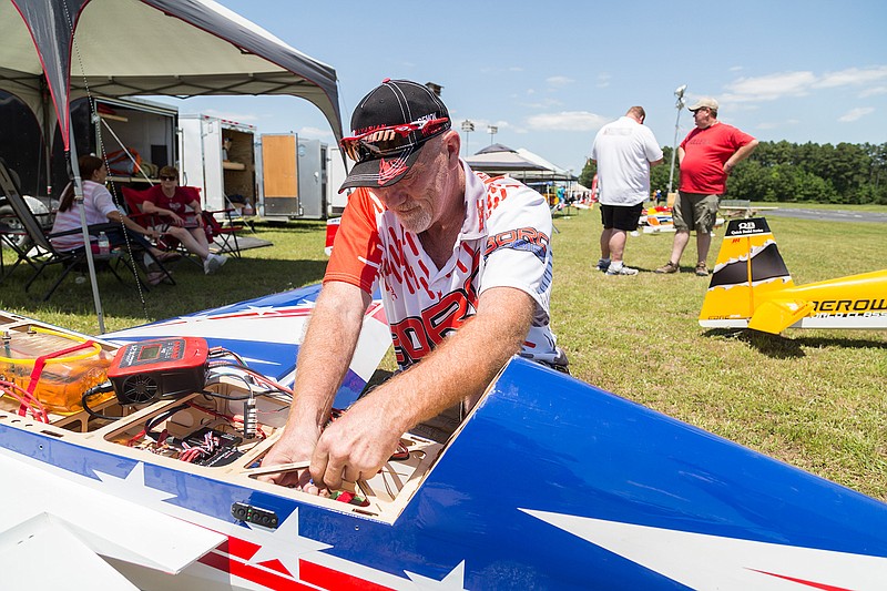  Kelley Payne recharges the battery of the servo motors that control his plane Saturday, April 23, 2016 at Wright Patnam Dam. Payne has been flying radio-controlled planes for 40 years.