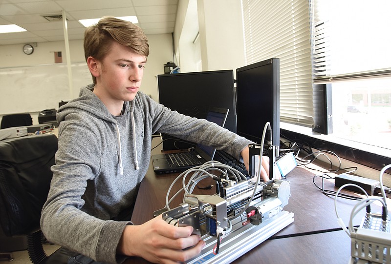 Phillip Branch troubleshoots a stacking station in Mechatronics class at Nichols Career Center.