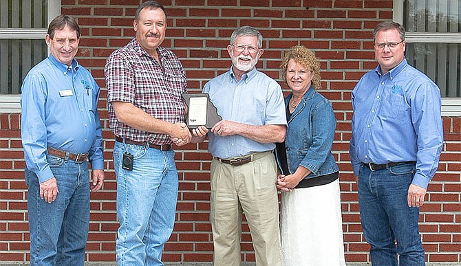 The plaque for 2015 Moniteau County Soil and Water Conservation District (SWCD) Cooperator of the Year is Charlie and Kathy Cole, California. Pictured, from left, Resource Conservationist Ric Heckman, SWCD Board Chairman Darrell Hoellering, Charlie and Kathy Cole and District Conservationist Tony Hoover.