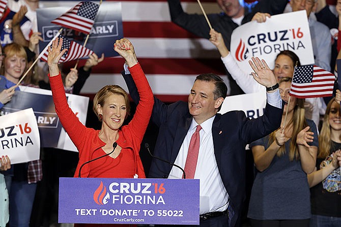 Republican presidential candidate Sen. Ted Cruz, R-Texas, joined by former Hewlett-Packard CEO Carly Fiorina, waves during a rally in Indianapolis, Wednesday, April 27, 2016, when Cruz announced he has chosen Fiorina to serve as his running mate.