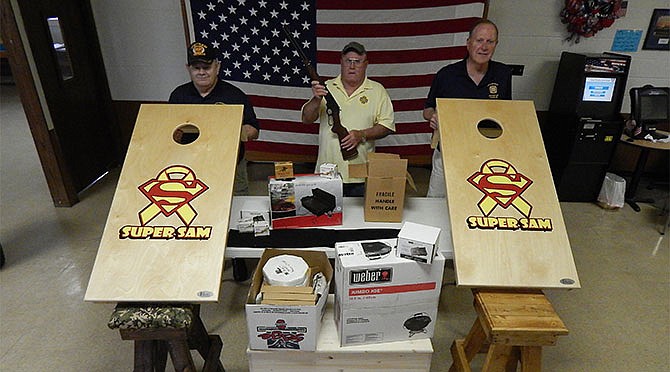 VFW Post 2657 members Joe Kemp (left), Larry Underwood and Wayne Bill with some of the items to be in
a silent auction on May 7. More donations are needed for this fundraiser for the Super Sam Foundation. Call
Underwood at 573-592-9003 for more information.