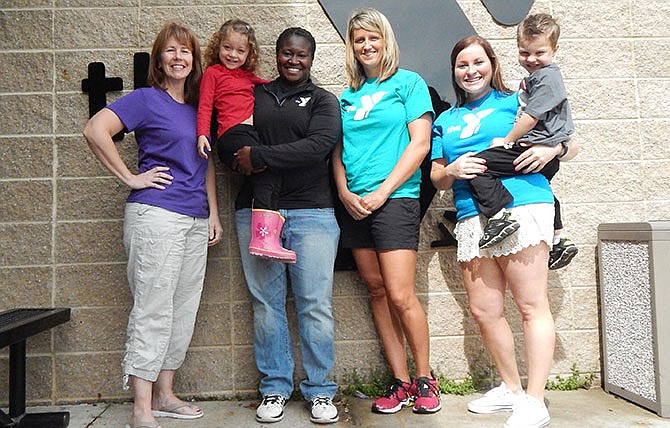 Officials at the YMCA of Callaway County are preparing for their Saturday fundraiser, Color Burst 5K and Healthy Kids Day. They include (from left) Melissa Siegel, membership director; Talisha Washington, program director; Sara McDaniel, CEO; and Beth Oseroff, marketing director; and their young friends Isabella Adams and Drew Lowe.