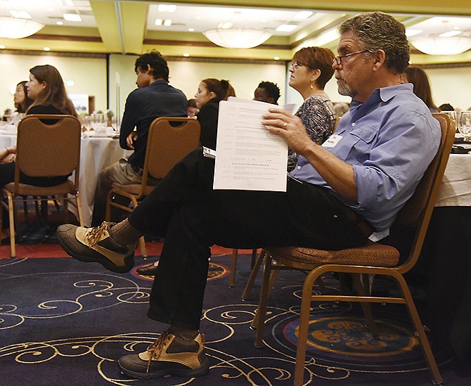 Stu Murphy and Suzanne Luther listen as Anita J. Dunning, the state director of rural development for the United States Department of Agriculture, delivers her keynote speech at Wednesdayâ€™s Statewide Poverty Summit at the Capitol Plaza Hotel. She talked about rural and urban poverty and food insecurity and how to try to help get food from producers to the people who need it. Murphy is with Empower Missouri and Luther recently started Four Quarters Art House.