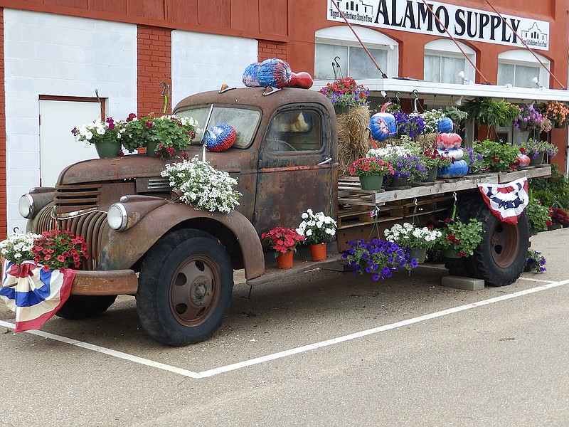Alamo Supply owners Steve and Glenda Wilson of Maud, Tx. borrowed this old truck from a friend as they wanted to decorate it to commemorate the Bankhead Highway tour that came through their small town on U.S. Highway 67. The truck was a 1946 army surplus vehicle from World War II. It has been sitting in a field as of late, but is seeing new life as it rests at the intersection of Highway 67 and U.S. Highway 8. The truck has a little bit of colorful history attached to it: there are grown men in town who can remember riding in that truck on road trips to Texarkana. One of the boys, about 50 years ago, thought it would be funny and dropped the key to the truck into the gas tank. The truck has a large old crank on the front from the days when that was necessary to start the engine. 