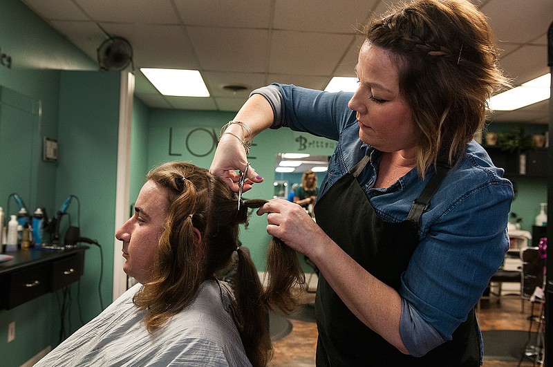 Kyle Forte has ponytails of his hair cut by stylist Anna Manson for Wigs for Kids on Wednesday, April 27, 2016 at Stylerz Studio in Nash, Texas. 