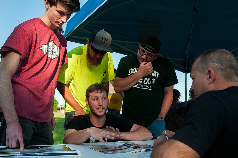 Matthew Kennedy, from left, David Hanson, Kevin Kjllander and Shon Foreman speak with American Ramp Co. President Nathan Bemo during a skate park design meeting Wednesday, April 27, 2016 at Kidtopia Park. 