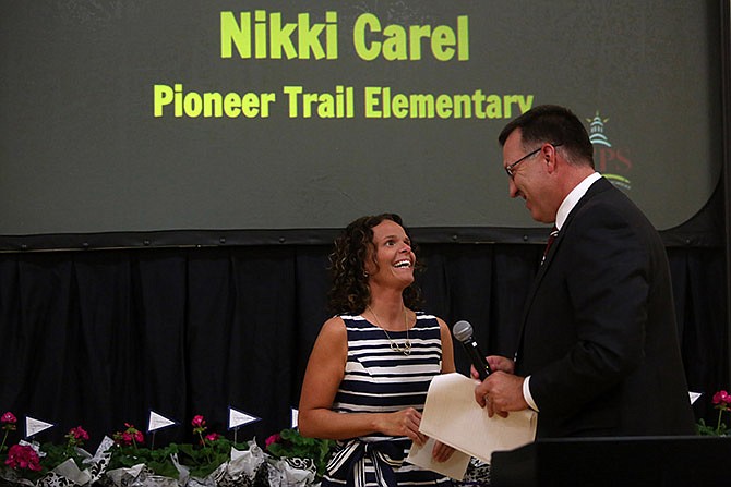 Nikki Carel, left, is named 2016 Teacher of the Year by Superintendent Larry Linthacum during the Jefferson City Public Schools Teacher Appreciation Banquet at Lewis and Clark Middle School.