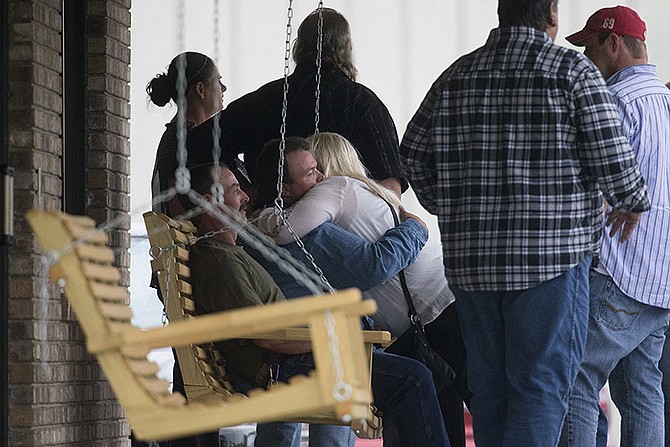 Visitors gather for the wake of Gary Rhoden on Wednesday at the Crockett L. Reed Funeral Home in South Shore, Kentucky. Multiple people, including Rhoden, were found dead Friday at several properties near Piketon, Ohio. Investigators have interviewed more than 50 people in the case but have made no arrests. 