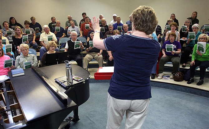 Suzanne Barner Kitchen, center, directs the Jefferson City Cantorum April 14 during a rehearsal at the First Baptist Church in downtown Jefferson City.