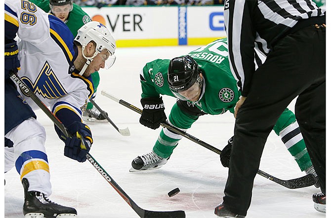 St. Louis Blues center Paul Stastny (26) and Dallas Stars left wing Antoine Roussel (21) face off for the puck during the first period in Game 1 in the second round of the NHL Stanley Cup playoffs Friday, April 29, 2016, in Dallas.