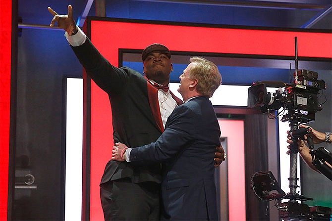 Mississippi Stateâ€™s Chris Jones celebrates with NFL Commissioner Roger Goodell after being selected by the Kansas City Chiefs as the 37th pick in the second round of the 2016 NFL football draft, Friday, April 29, 2016, in Chicago.