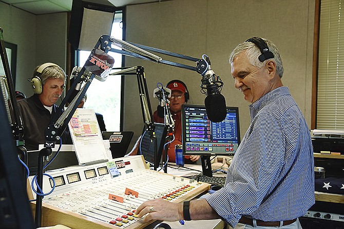 With a studio full of well-wishers, Warren Krech slides the knobs for the last time at the conclusion of his personal comments Friday morning, April 29, 2016. After 42 years behind the microphone on radio, the last 30 of those in Jefferson City, Krech broadcast for the last time on air. Several former on-air co-workers stopped by KWOS to say thank you for taking a chance on them and to wish him well in his retirement. Standing at left is John Marsh and in back is Hal Dulle. 